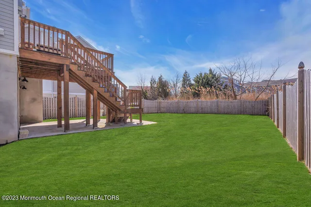 a view of yard with swimming pool and green space