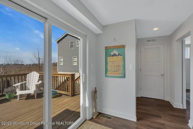 a view of a hallway with wooden floor and dining room