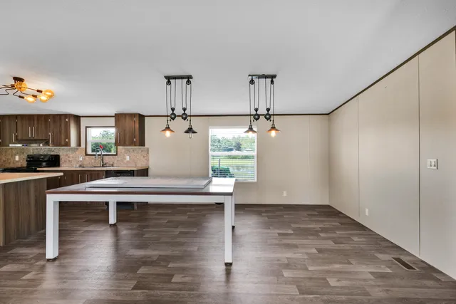 a living room with kitchen island furniture and a wooden floor
