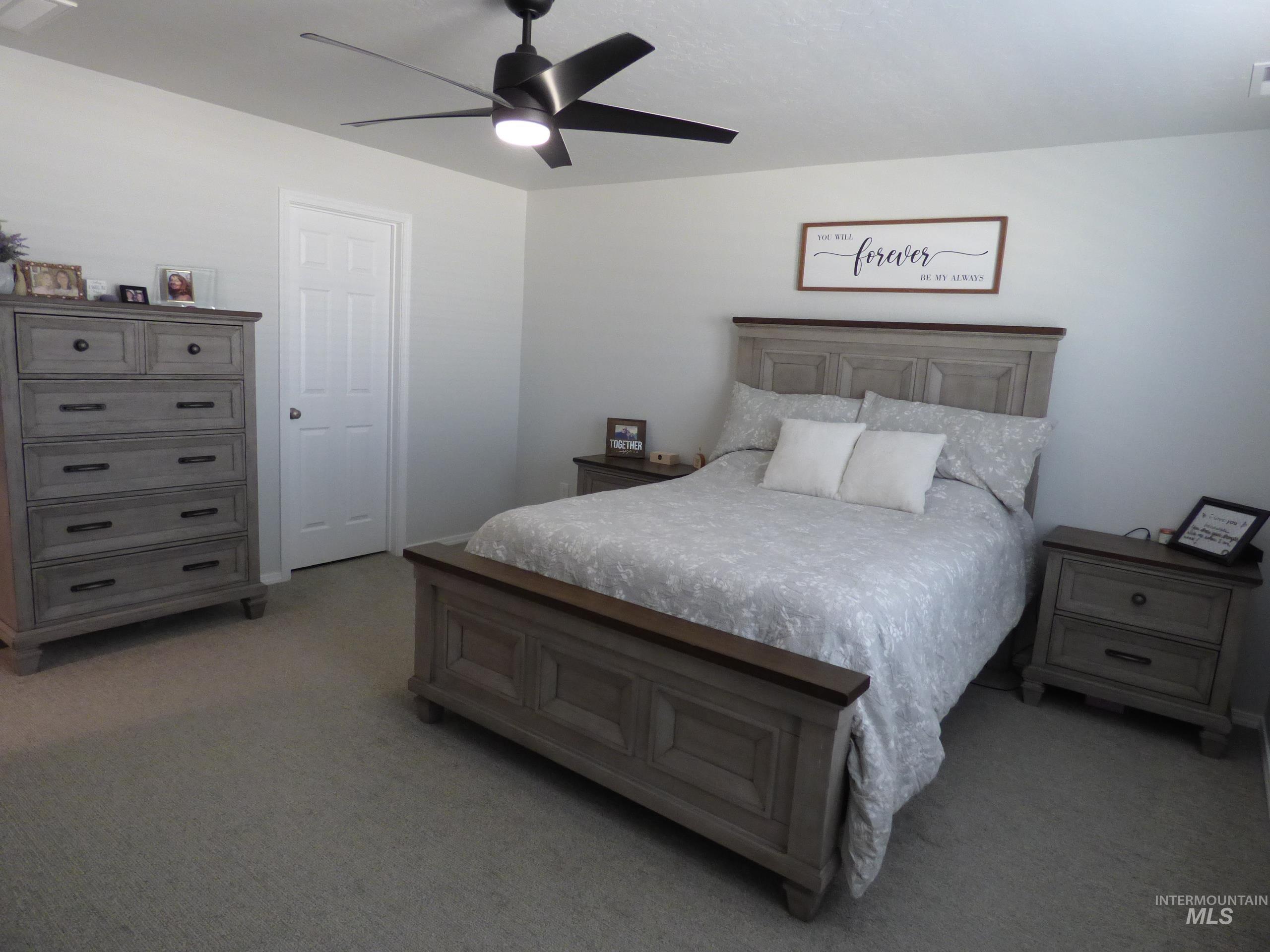 2708 East Buckaroo Drive Kuna, ID 83634 - Photo 18 of 48 Spacious room featuring neutral carpeting, light-colored walls, a ceiling fan with integrated lighting, and a paneled white door