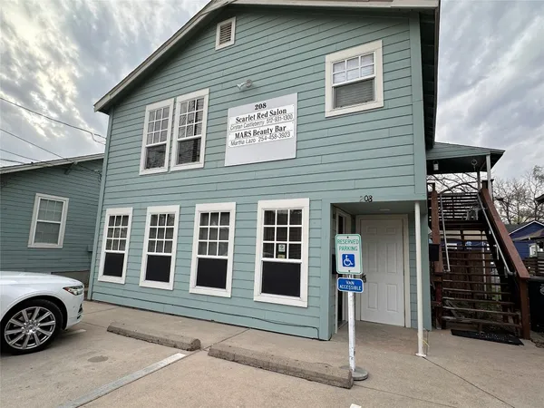 a front view of a house with parking space