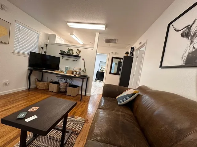 a living room with furniture and a flat screen tv