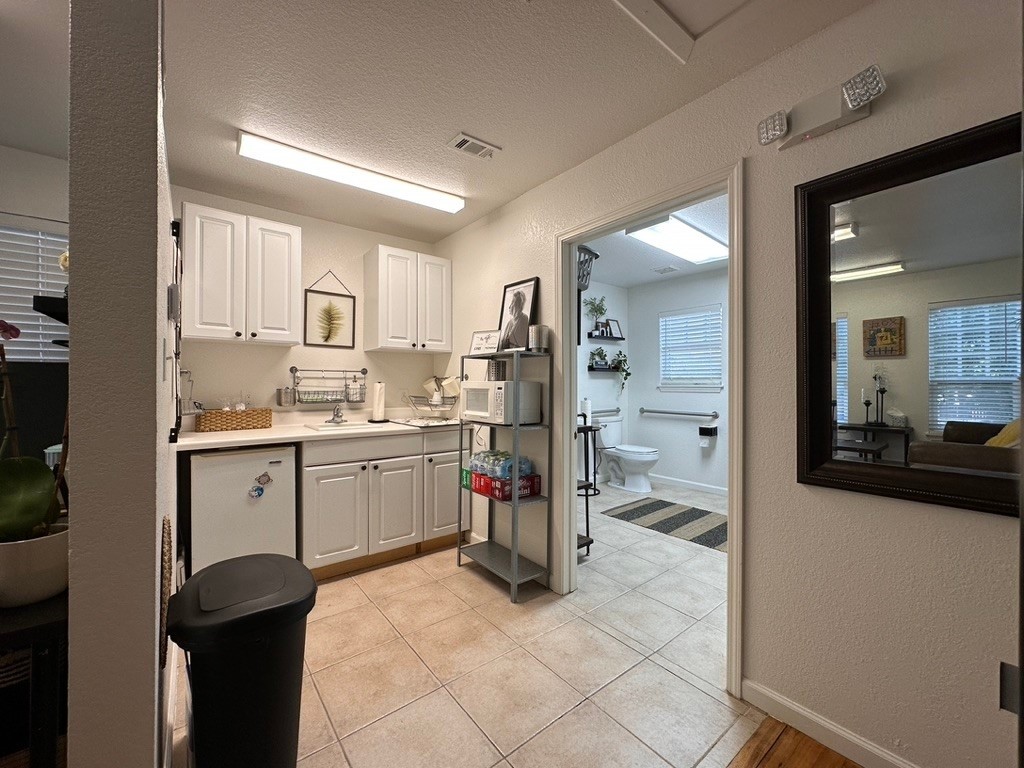 208 West 10th Street, Unit 201 Georgetown, TX 78626 - Photo 13 of 18 a kitchen with a sink and cabinets