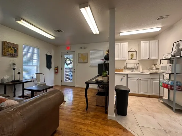 a living room with furniture a dining table and kitchen view