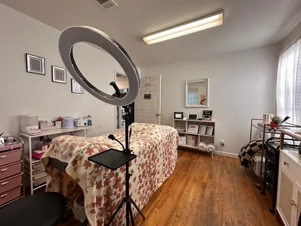 a bed room with furniture and a mirror