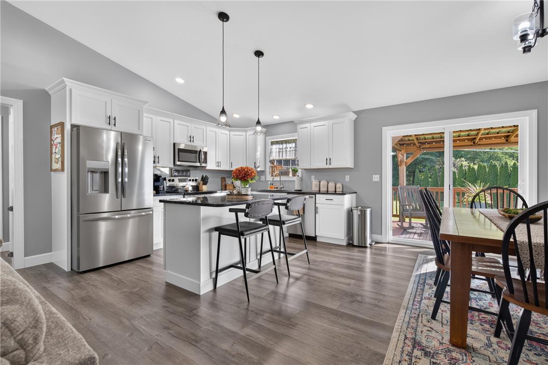 74 Kepners Road New Ringgold, PA 17960 - Photo 14 of 79 Vaulted ceilings and wide-plank flooring elevate this open-concept kitchen and dining space.