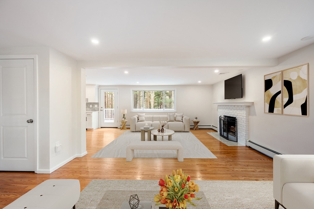115 Brook Bend Road Hanover, MA 02339 - Photo 14 of 42 a living room with fireplace furniture and a wooden floor