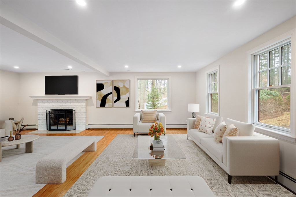115 Brook Bend Road Hanover, MA 02339 - Photo 16 of 42 a living room with furniture a fireplace and a flat screen tv
