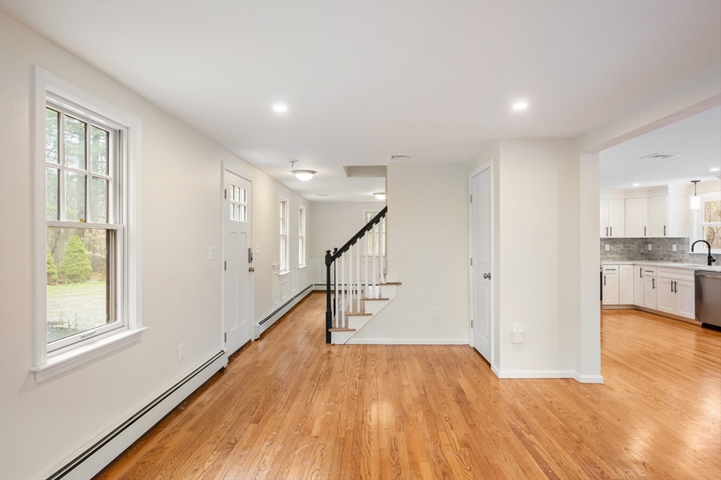 115 Brook Bend Road Hanover, MA 02339 - Photo 18 of 42 a view of empty room with wooden floor and kitchen