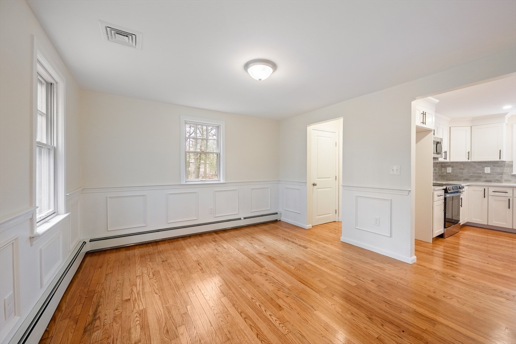 115 Brook Bend Road Hanover, MA 02339 - Photo 21 of 42 an empty room with wooden floor and windows