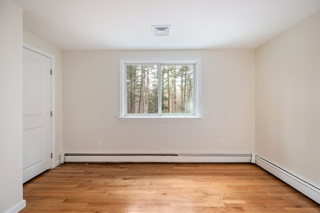 115 Brook Bend Road Hanover, MA 02339 - Photo 28 of 42 a view of an empty room with wooden floor and a window