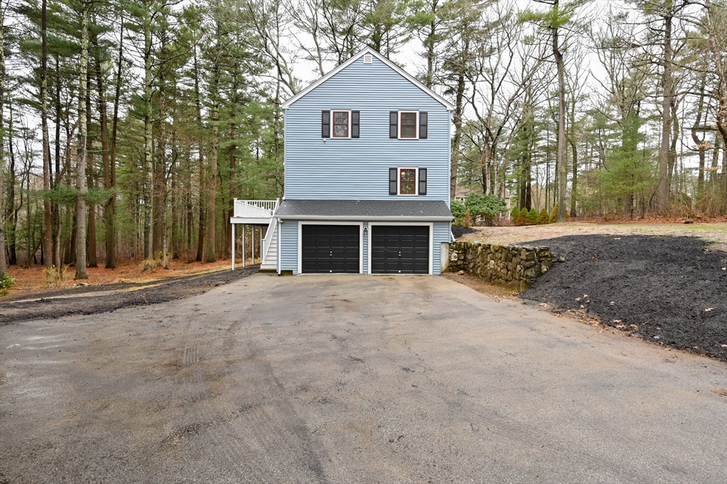 115 Brook Bend Road Hanover, MA 02339 - Photo 38 of 42 a front view of a house with a yard and garage