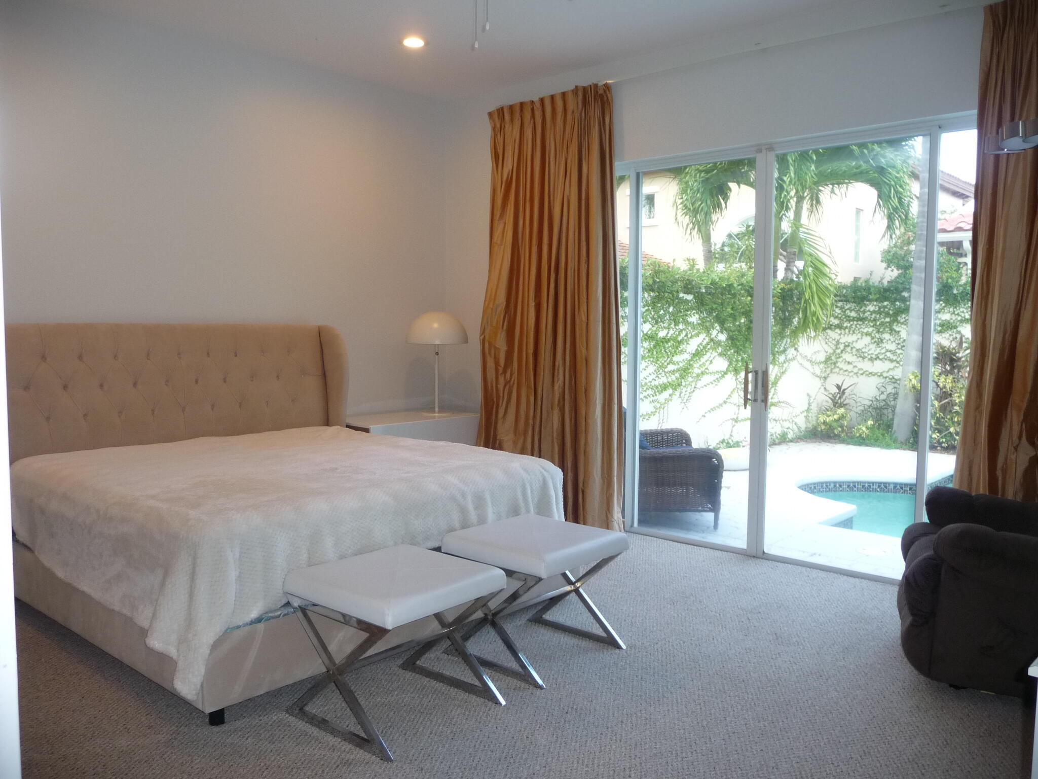 20694 Northwest 27th Avenue Boca Raton, FL 33434 - Photo 12 of 22 a bedroom with a bed and a large window with outer view