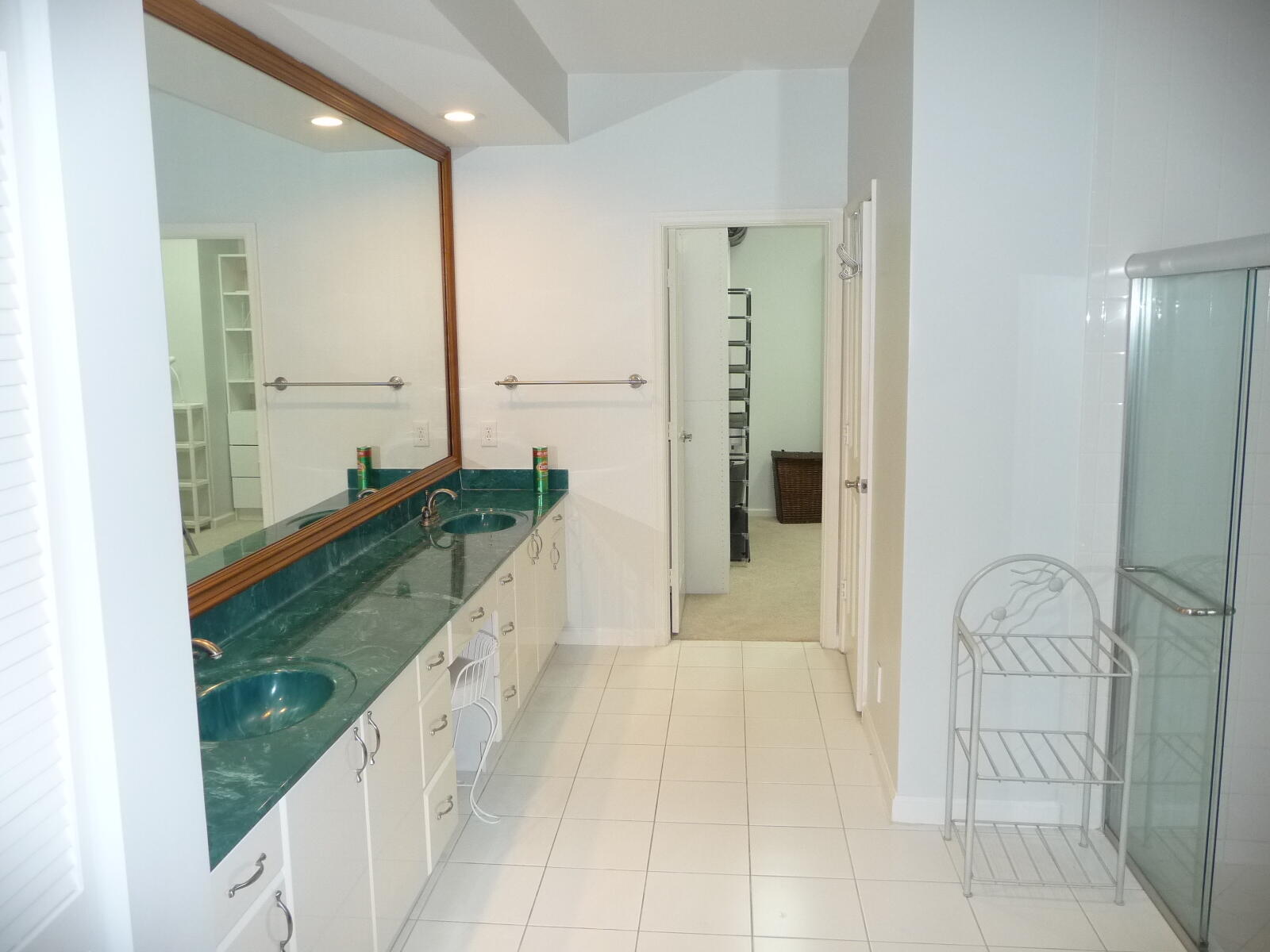 20694 Northwest 27th Avenue Boca Raton, FL 33434 - Photo 14 of 22 a spacious bathroom with a double vanity sink and a mirror