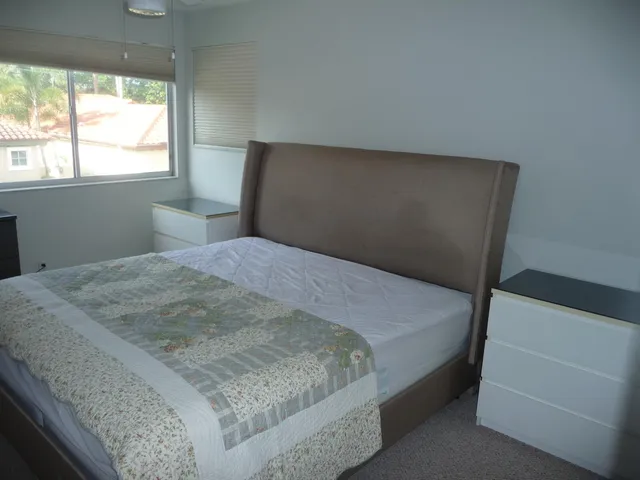 a bedroom with a bed and a window