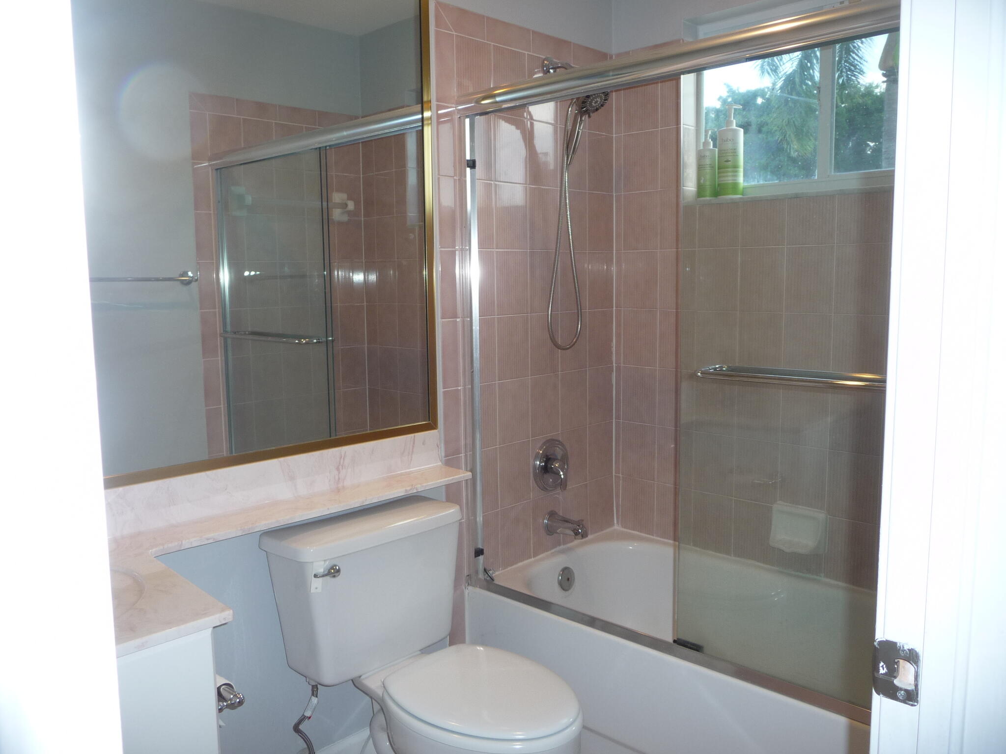 20694 Northwest 27th Avenue Boca Raton, FL 33434 - Photo 18 of 22 a bathroom with a shower a toilet and a bathtub