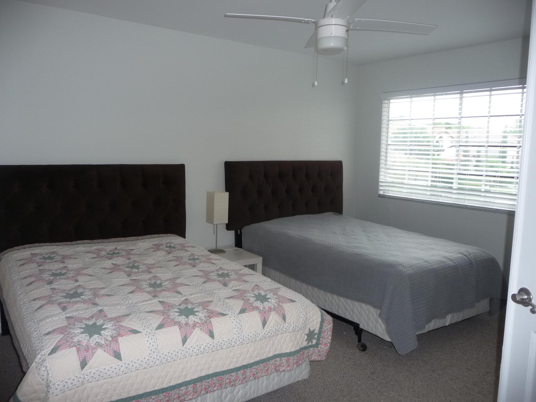 20694 Northwest 27th Avenue Boca Raton, FL 33434 - Photo 19 of 22 a bedroom with a bed and a window