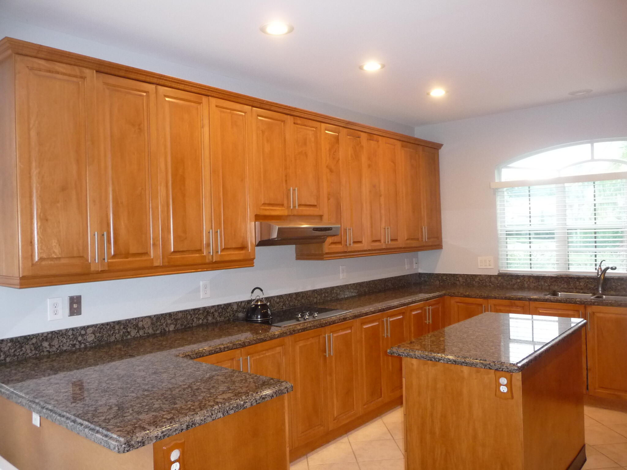 20694 Northwest 27th Avenue Boca Raton, FL 33434 - Photo 2 of 22 a kitchen with a sink a counter top space and cabinets