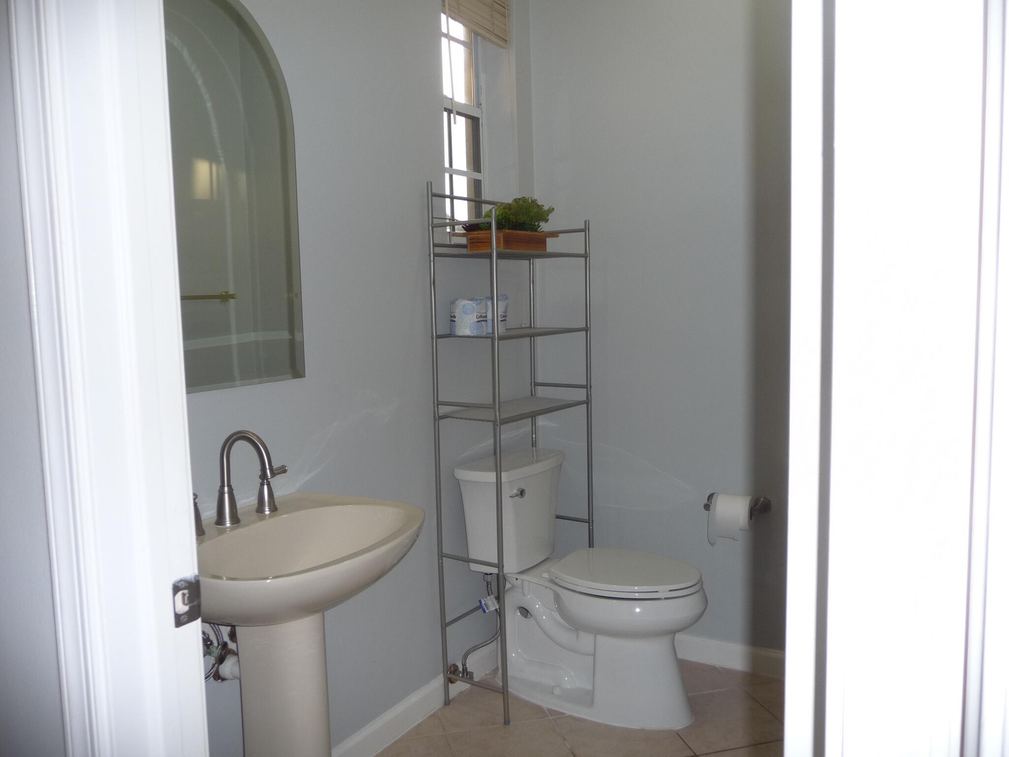 20694 Northwest 27th Avenue Boca Raton, FL 33434 - Photo 21 of 22 a bathroom with a toilet sink and mirror