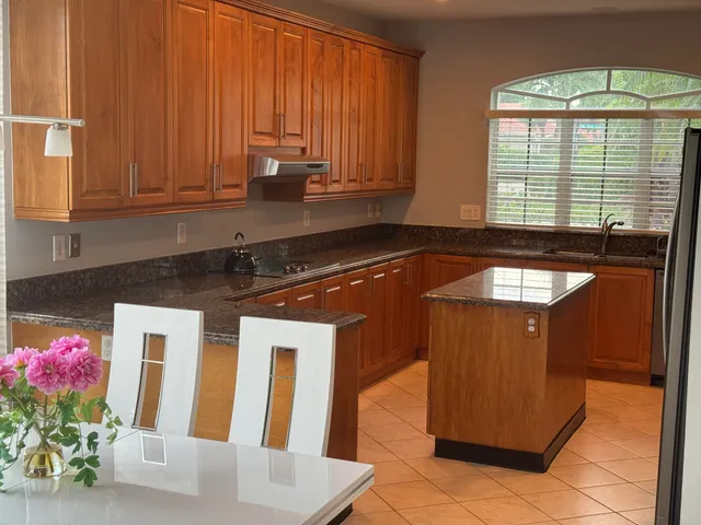 a kitchen with furniture and a potted plant