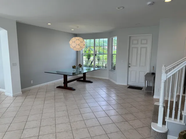 a bedroom with a bed and a large window with outer view