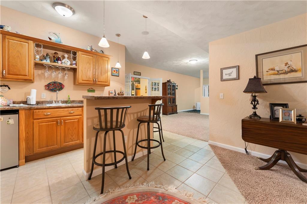 193 Lentz Road Latrobe, PA 15650 - Photo 26 of 45 a kitchen with stainless steel appliances kitchen island granite countertop a sink a stove a dining table and chairs