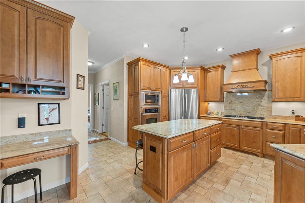193 Lentz Road Latrobe, PA 15650 - Photo 8 of 45 a large kitchen with kitchen island granite countertop a sink a counter space and stainless steel appliances