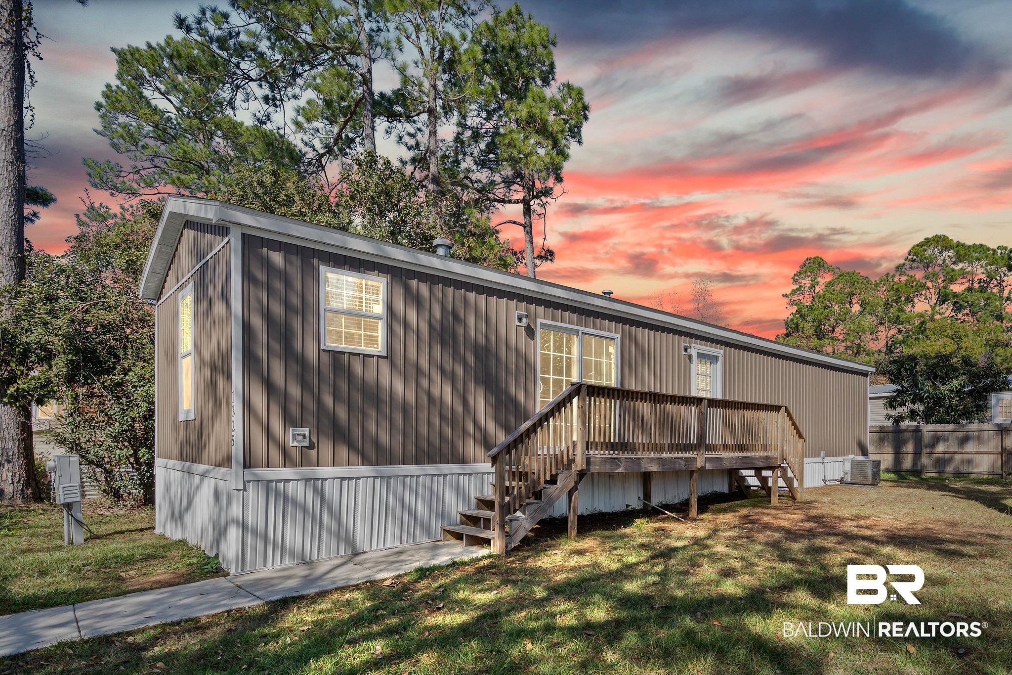 1325 Ridgewood Drive Lillian, AL 36549 - Photo 21 of 32 Back of house at dusk with stairway and a deck