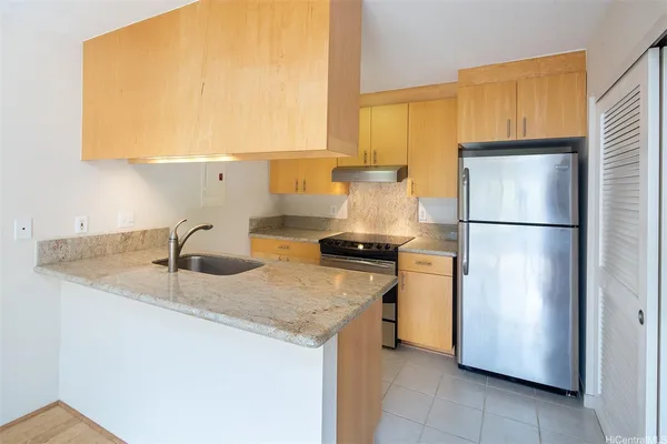 a kitchen with stainless steel appliances granite countertop a sink and a stove
