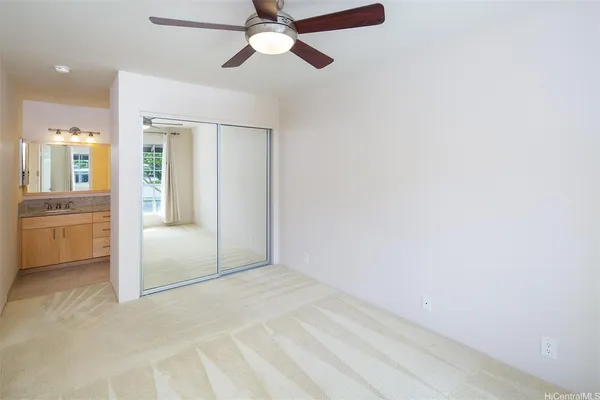 a bathroom with a granite countertop sink a mirror a vanity and a shower