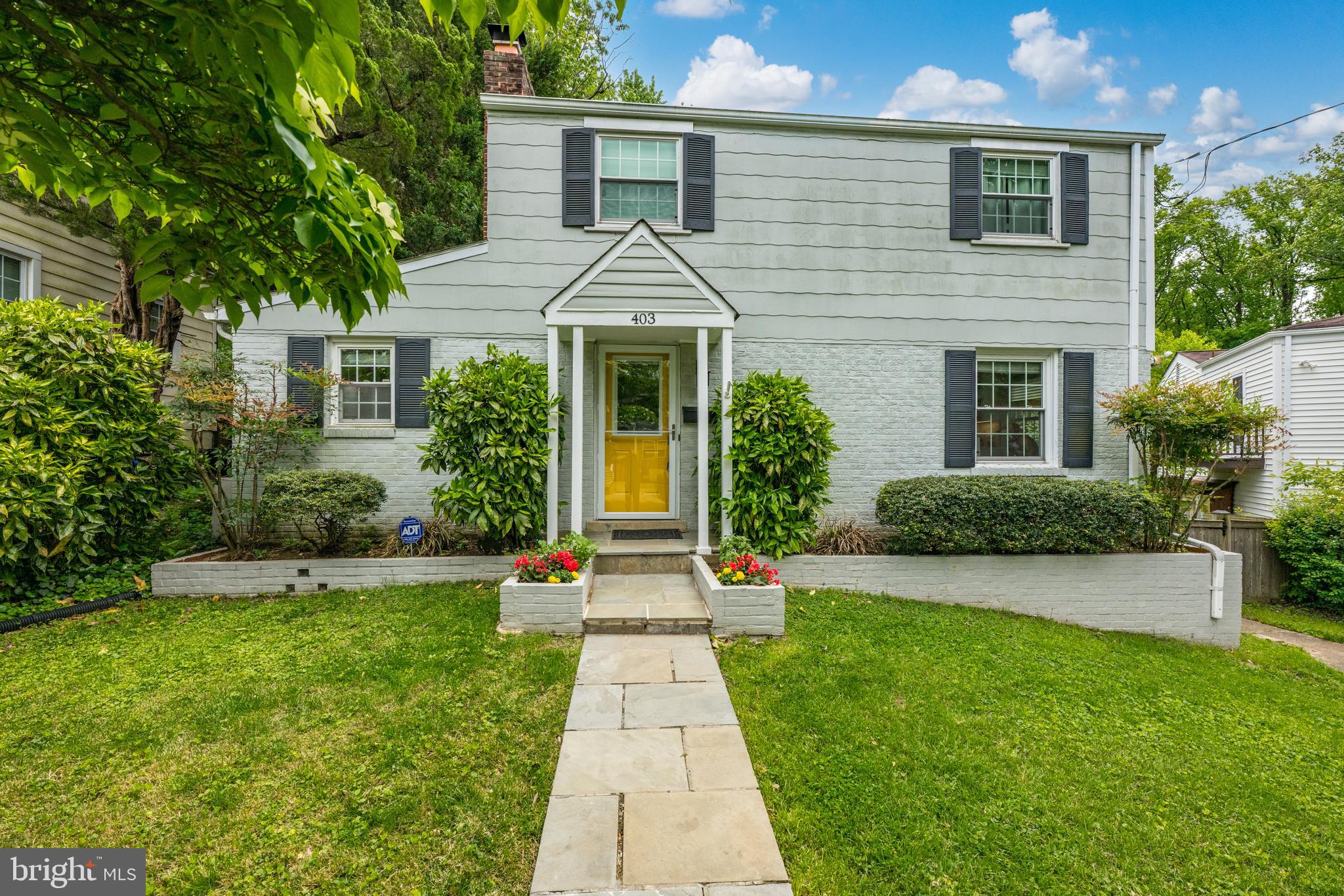 403 East Melbourne Avenue Silver Spring, MD 20901 - Photo 1 of 33 a front view of a house with a yard and trees