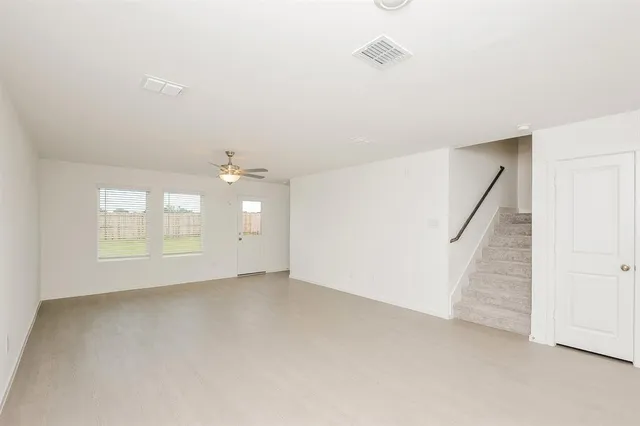 a view of an empty room with a window