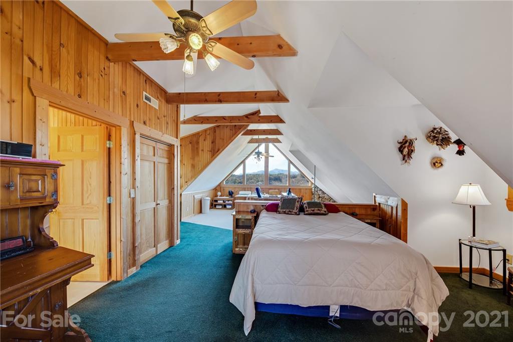976 Freemantown Road Rutherfordton, NC 28139 - Photo 17 of 23 a bedroom with a bed and a chandelier