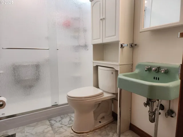 a white toilet sitting next to a bathroom sink