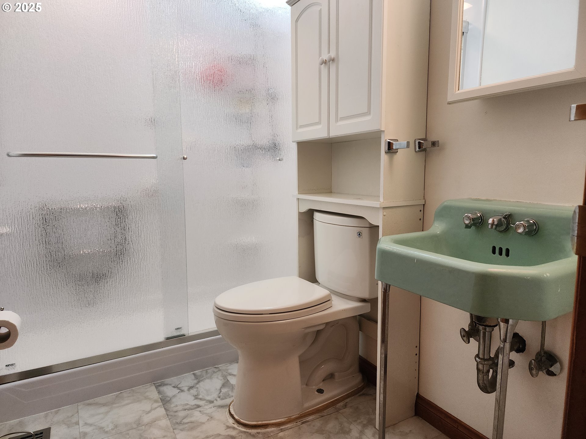 4081 Hawthorne Avenue Northeast Salem, OR 97301 - Photo 12 of 25 a white toilet sitting next to a bathroom sink