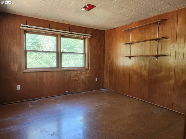 an empty room with a empty space and windows