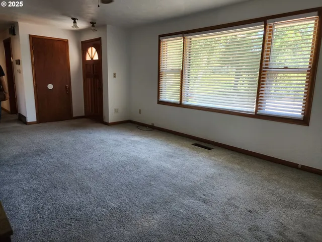 an empty room with windows and closet