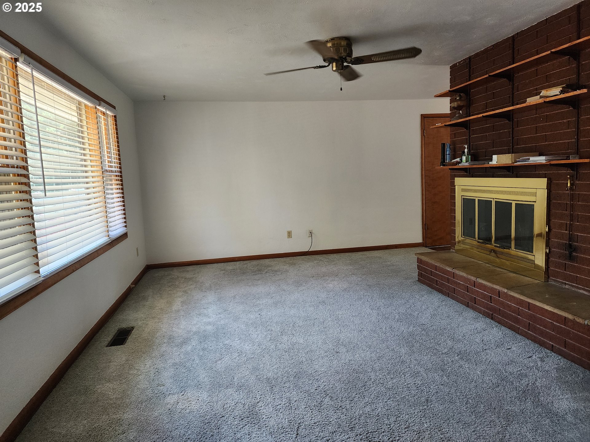 4081 Hawthorne Avenue Northeast Salem, OR 97301 - Photo 7 of 25 a view of an empty room with a fireplace and a window