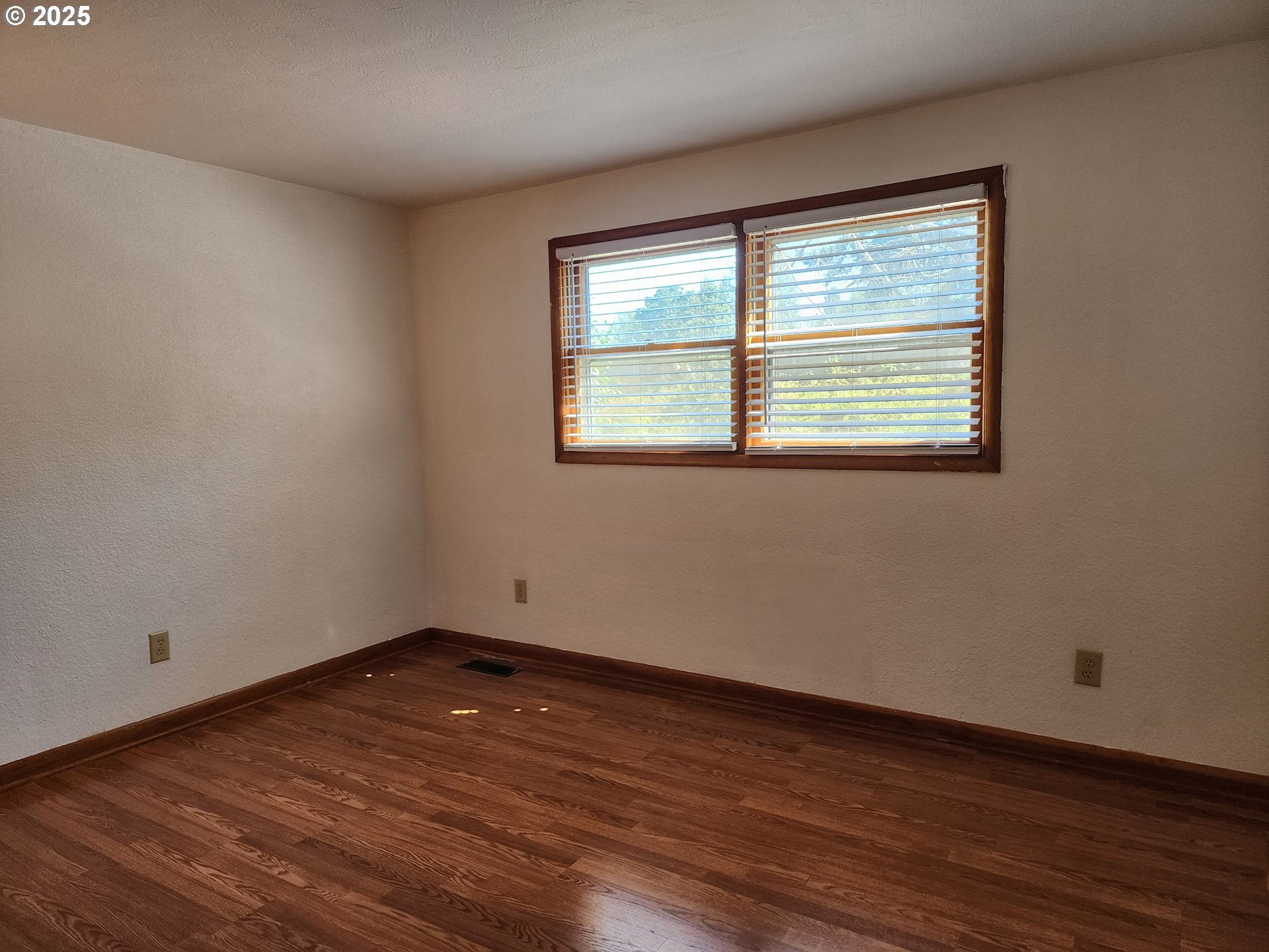 4081 Hawthorne Avenue Northeast Salem, OR 97301 - Photo 8 of 25 a view of an empty room with wooden floor and a window