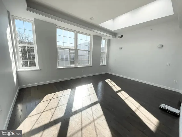 a bedroom with a large bed and a potted plant