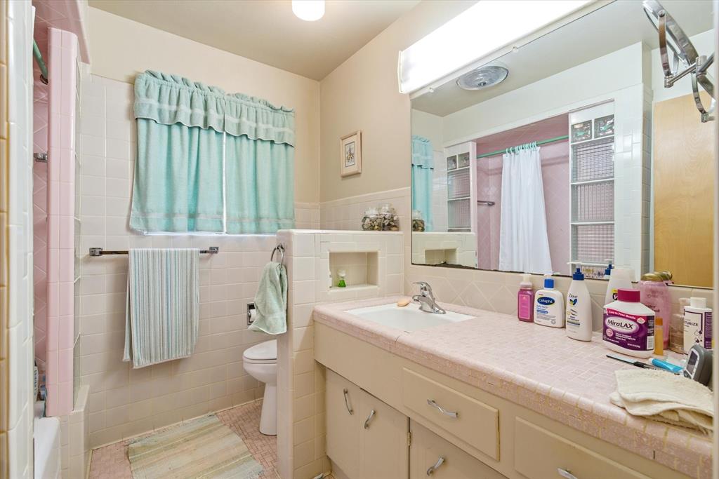 1910 Goodnight Boulevard Wills Point, TX 75169 - Photo 18 of 37 a bathroom with a sink a toilet and a large mirror