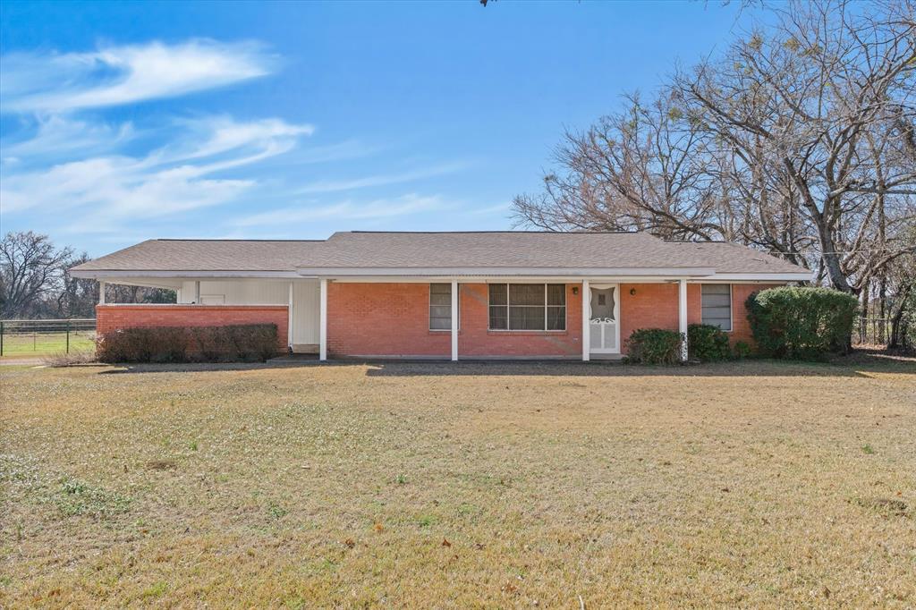 1910 Goodnight Boulevard Wills Point, TX 75169 - Photo 2 of 37 a front view of a house with a yard and garage