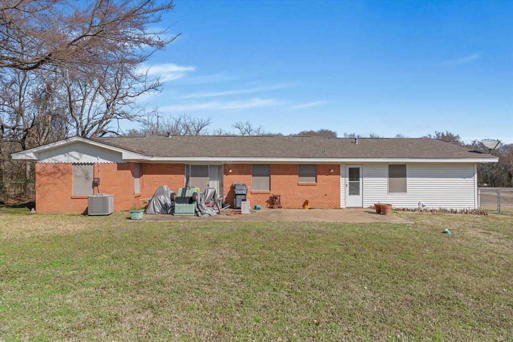 1910 Goodnight Boulevard Wills Point, TX 75169 - Photo 22 of 37 a front view of house with yard and trees in the background