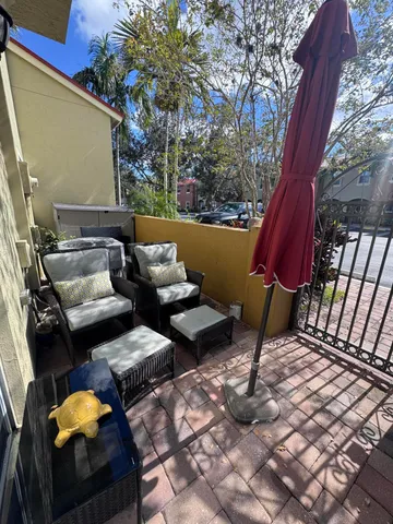 a backyard of a house with barbeque oven table and chairs