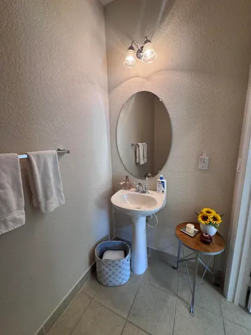 a white toilet sitting next to a white wall