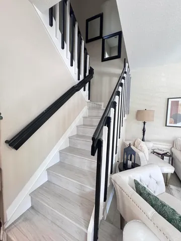 a bedroom with a bed next to a window with a bookshelf