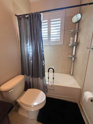 a bedroom with furniture and a book shelf