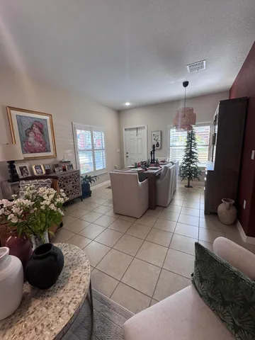 a living room with furniture and a potted plant