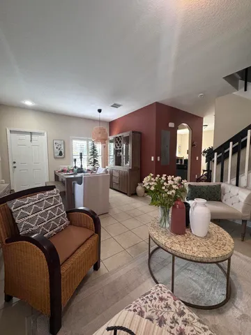 a living room with furniture flowerpot and wooden floor