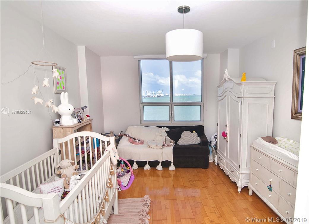 808 Brickell Key Drive, Unit 802 Miami, FL 33131 - Photo 11 of 48 A spacious second bedroom with hard wood floors and stunning bay views.